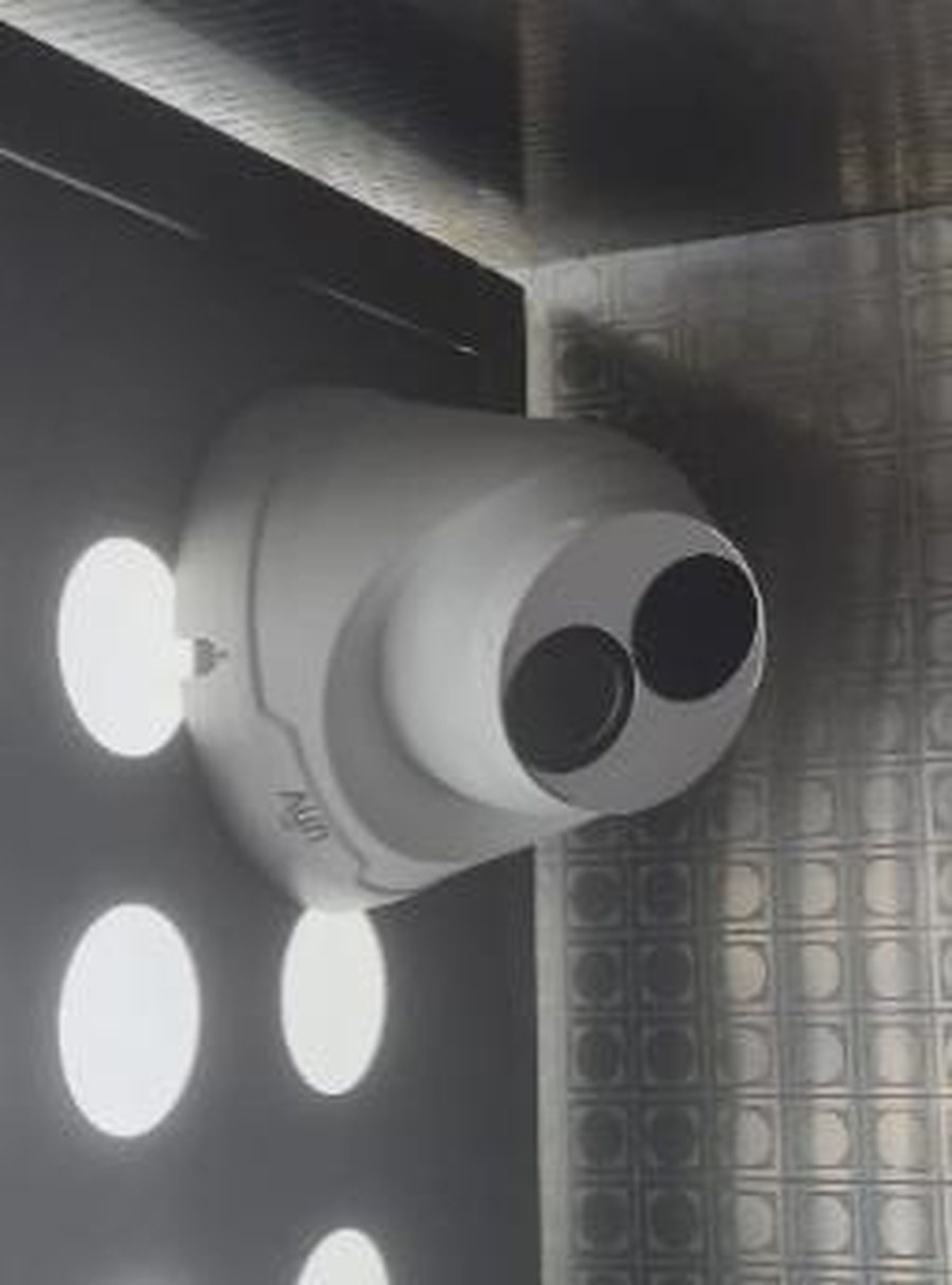 Camera-equipped intercom speaker mounted in a lift car ceiling